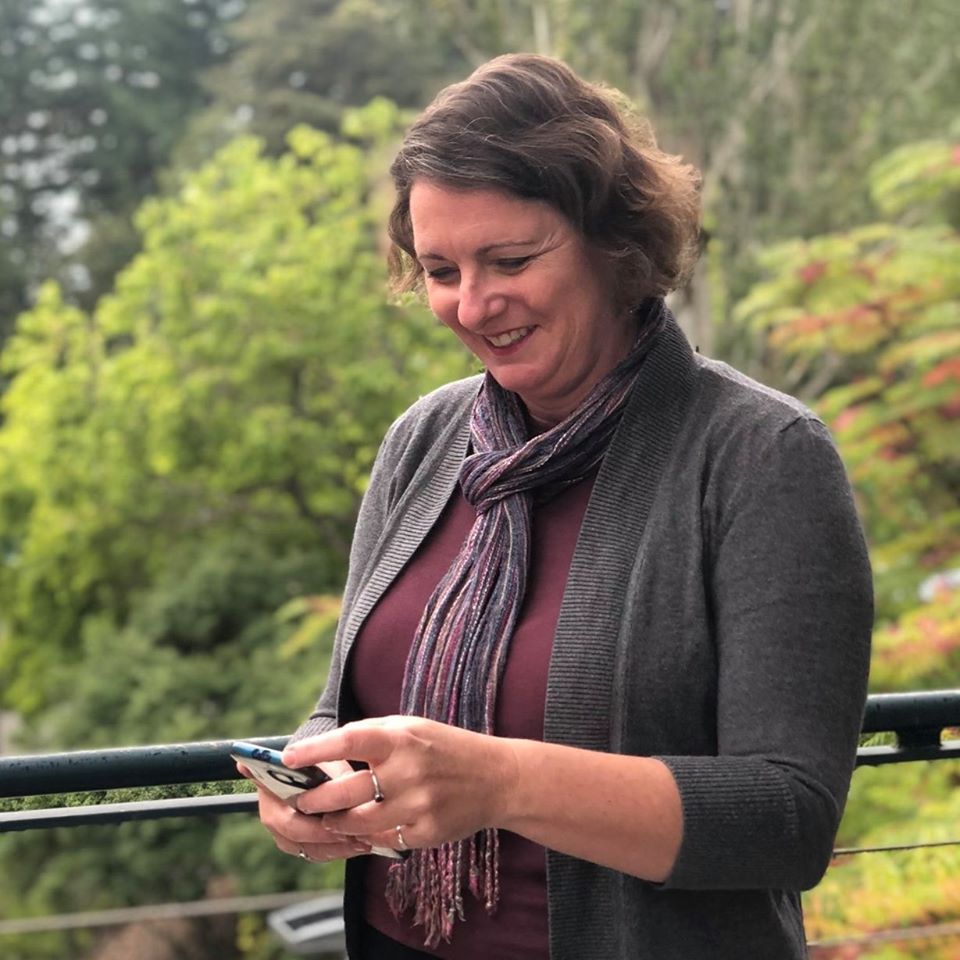 Outside in nature, looking at my phone.