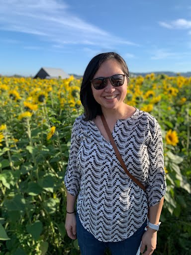 Photo of Lisa in a sunflower field. 