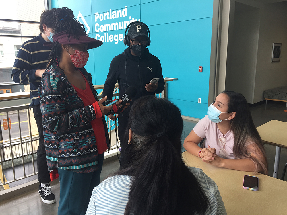 Students in the podcast class practice recording in different locations and practice doing interviews.