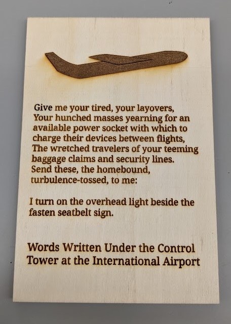 Give me your tired, your layovers, Your hunched masses yearning for an available power socket with which to charge their devices between flights, The wretched travelers of your teeming baggage claims and security lines. Send these, the homebound, turbulence-tossed, to me: I turn on the overhead light beside the fasten seatbelt sign. Words Written Under the Control Tower at the International Airport