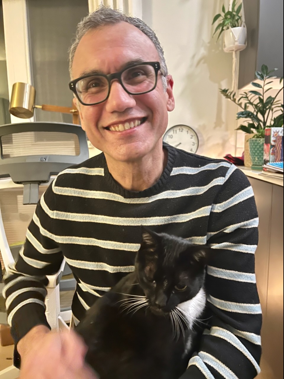Paul Montone holding a tuxedo cat named Punky