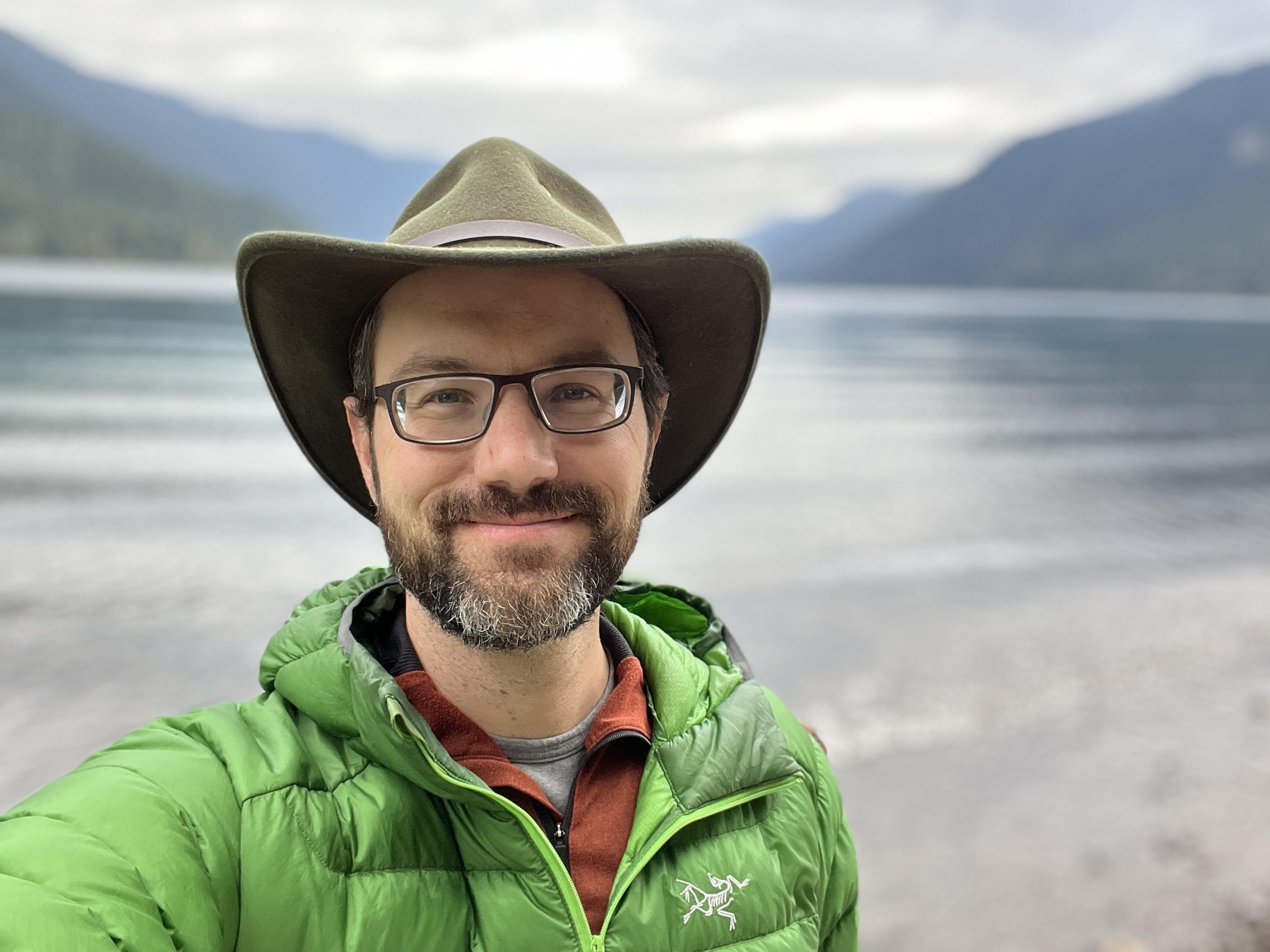 A photograph of Ross next to a lake.