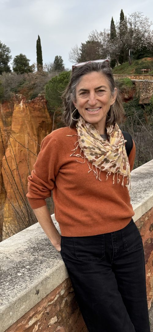 A picture of Shari in an orange sweater