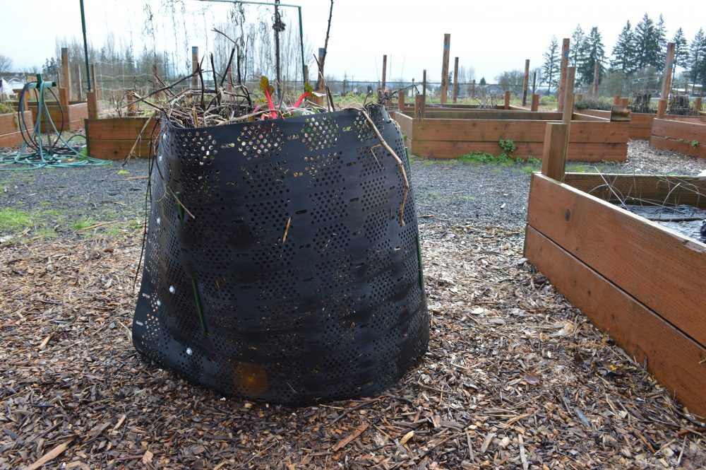 Geobin with a compost aerator tool