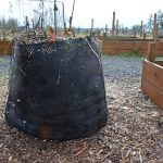 Geobin with a compost aerator tool