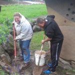 People digging in garden