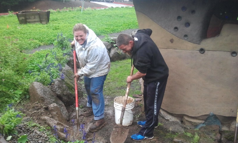 People digging in garden