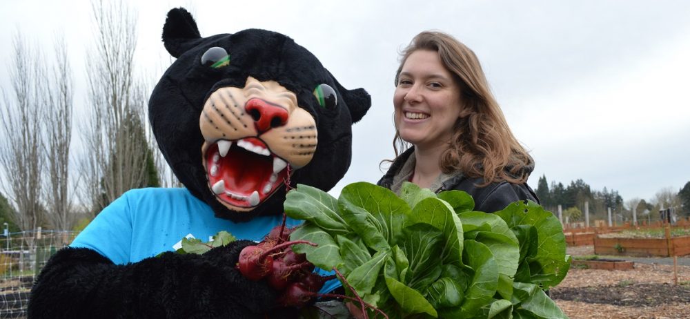 Poppie holding vegetables at the Learning Garden