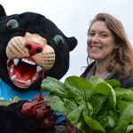 Poppie holding vegetables at the Learning Garden