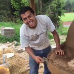 Person building cob oven