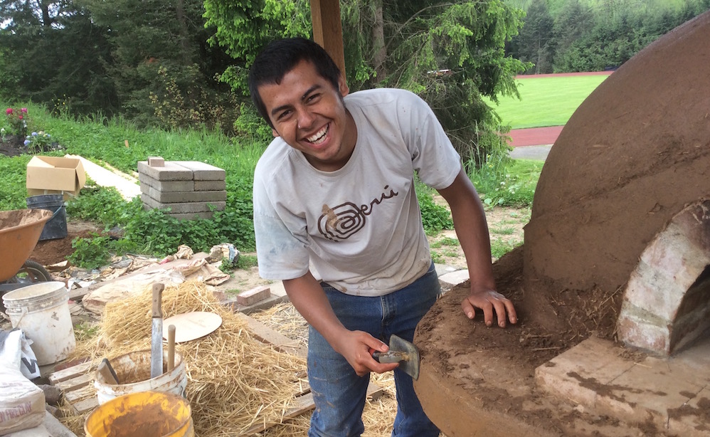 Person building cob oven