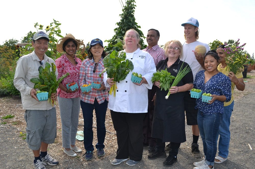 Dining services staff with learning garden produce
