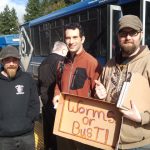 Holding Worms or Bust sign