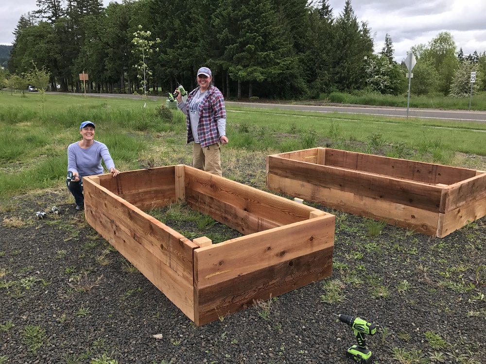 People building raised garden beds