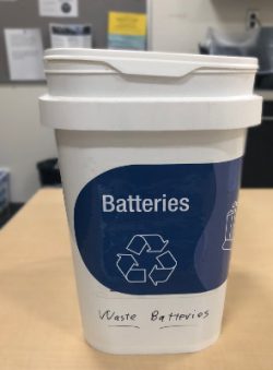 Recycling bucket, labeled "batteries".