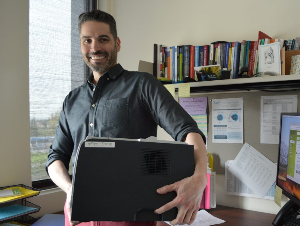 man carrying printer away.