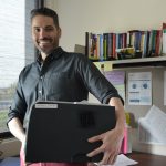 man carrying printer away.