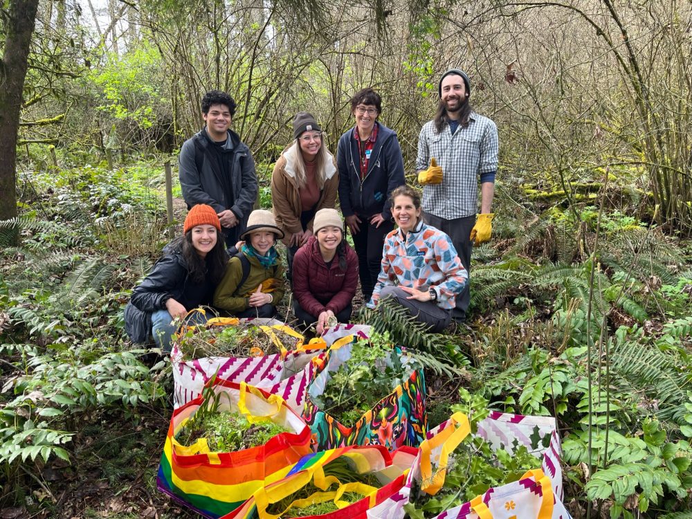 Eight people gathered for a photo during a trail clean up