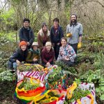 Eight people gathered for a photo during a trail clean up