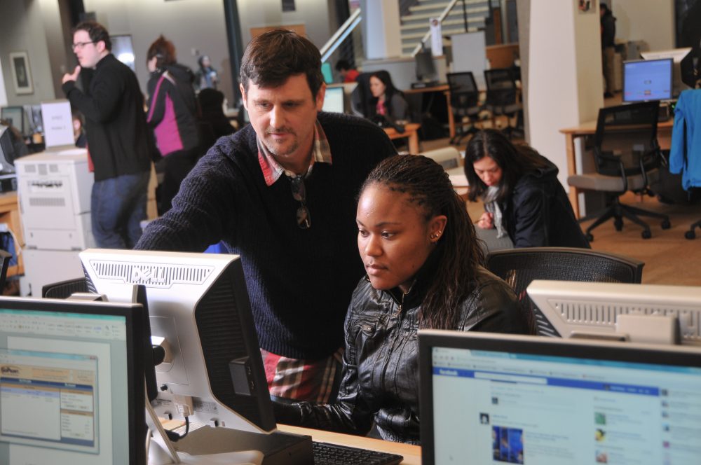Student and tutor in computer lab