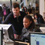 Student and tutor in computer lab