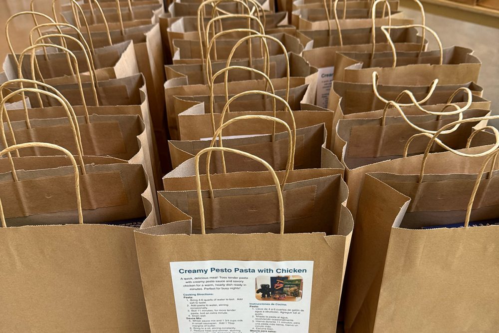 Table full of delivery meals in paper bags