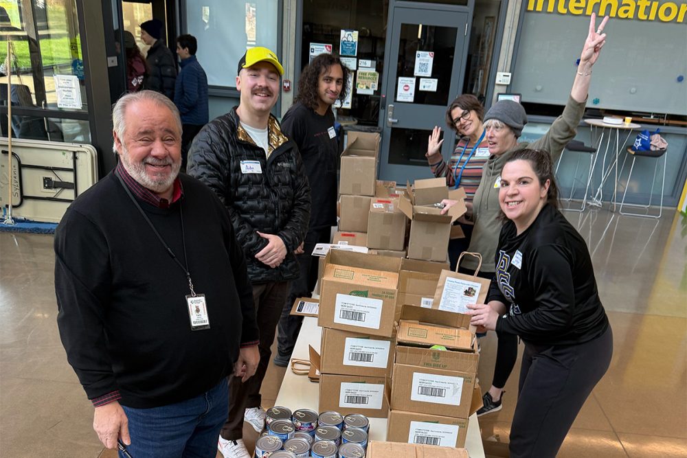 Group preparing food donations at a table