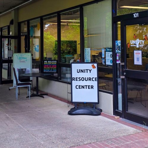 Window lined front wall and entrance with sign for Unity Resource Center