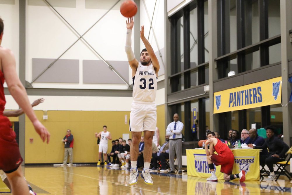 #32 in white B-Ball uniform shoots.