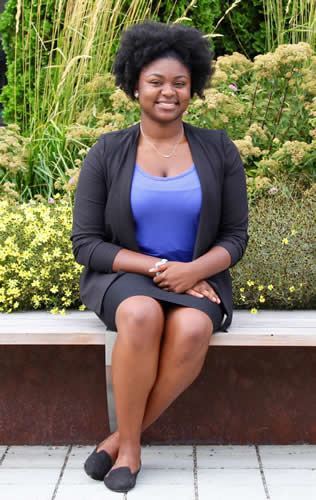 Photo of a woman - she is out of focus but the flowers behind her are in focus