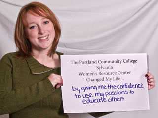 Scholarship recipient holding a sign that says 'By giving me the confidence to se my passions to educate others'