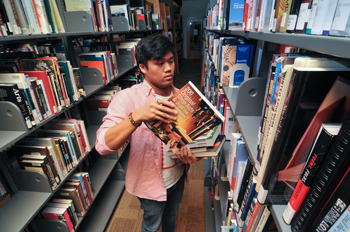 student shelving books