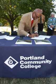 PCC President Preston Pulliams signs the plan.