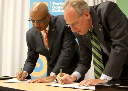 PCC District President Preston Pulliams (left) and PSU President Wim Wiewel sign the new dual enrollment agreement at an event on Wednesday, Jan. 18 at PCC's Downtown Center