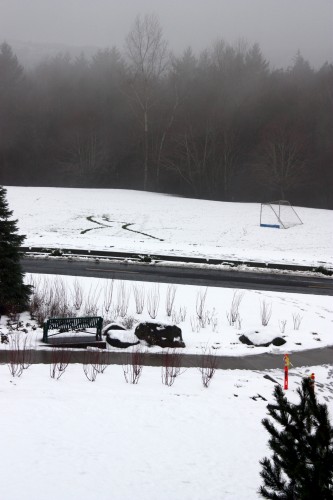 The snow from the morning melted some before another round of snow (background) hit the campus midday on Tuesday, Jan. 17.