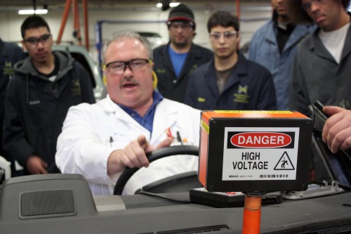 Automotive Service Technology instructor Russ Jones shows first term students the dangers of working on high voltage hybrid batteries.