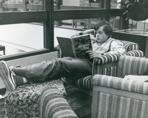A student in the late 1970s reads up on homework at the Rock Creek Campus.