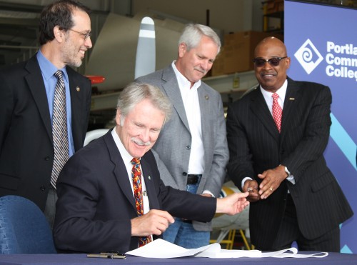 Gov. John Kitzhaber (seated) is seen here with PCC President Preston Pulliams (right) signing several education bills at the Rock Creek Campus in 2011.