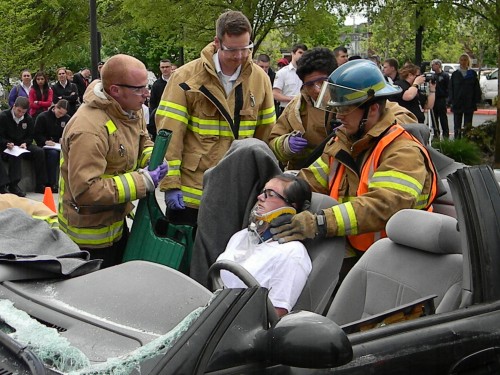 PCC Fire Protection Technology students stabilize a crash "victim" before he is removed from a wrecked vehicle.