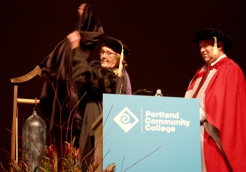 PCC Board Chair Denise Frisbee unveils the handcrafted gift bell (made by faculty Phil Seder) that was given to college president Jeremy Brown during the PCC Investiture on Wednesday, Oct. 30.