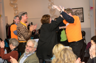 The PCC 2013 'World Quest' team celebrates its victory with cheers and hugs.