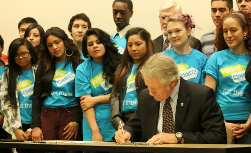 Dozens of students in the PCC Foundation’s Future Connect Program gathered around the Governor to watch him sign the bills in front of gathered media and legislators. 
