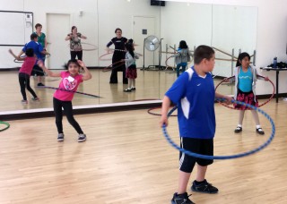 Alder students take a spin with hula hoops in the PCC dance studio.