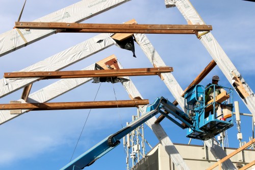 Workers put in place giant trusses on Oct. 8 to help support the new atrium entrance to the College Center.