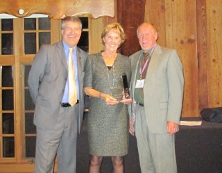 Denise Frisbee is handed her award by Kevin Talbert, right, president of the OCCA Executive Committee, and PCC President Jeremy Brown.