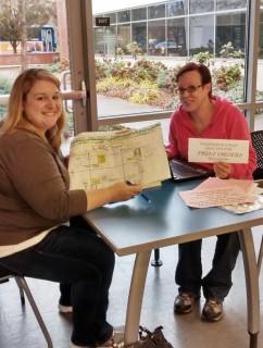 Students Kendal Kelleher and Mindy Cobb analyze the data they have collected from campus faculty and staff. 