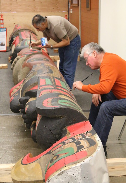 Award-winning Kwagiulth Native Artist Richard Hunt (foreground) and Sylvania’s Division Dean of Visual & Performing Arts Gene Flores spent two days in November fixing holes, rot damage and repainting the totem pole with bright colors to restore it to its previous glory.