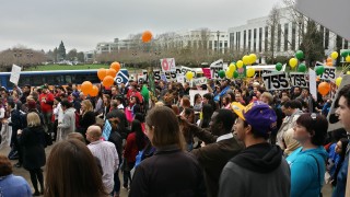 Rally Day at the Capitol Building with PCC's shuttle in the background.