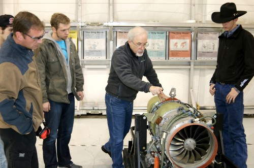 Aviation Maintenance Technology faculty Marshall Pryor (center) shows students, left to right, Edward Stravens, Michael Parkes and Jacob Rothgeb the new Williams International turbofan engine.