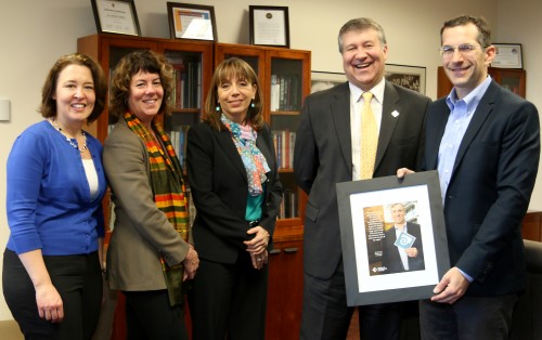 PCC President Jeremy Brown presents U.S. Sen. Jeff Merkley's Chief of Staff, Mike Zamore (far right), and his Education Policy Legislative Assistant, Susan Lexer (far left), a framed feature article honoring Sen. Merkley. Also on hand were, left to right, Traci Fordham (chief of staff) and Sylvia Kelley (vice president).